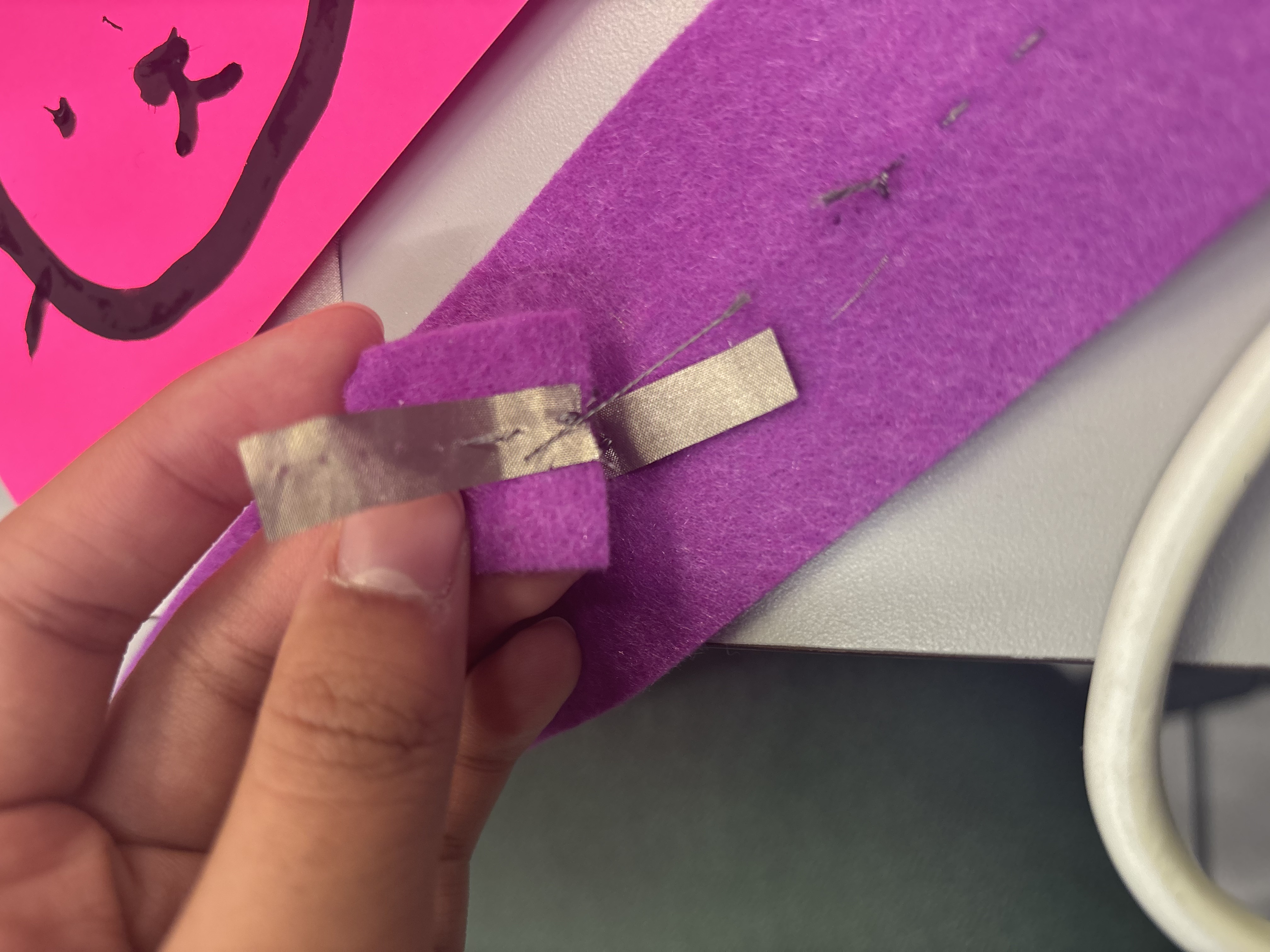 Attempt to make a batter pocket that is conductive using felt, conductive thread, conductive fabric, and a light bulb.