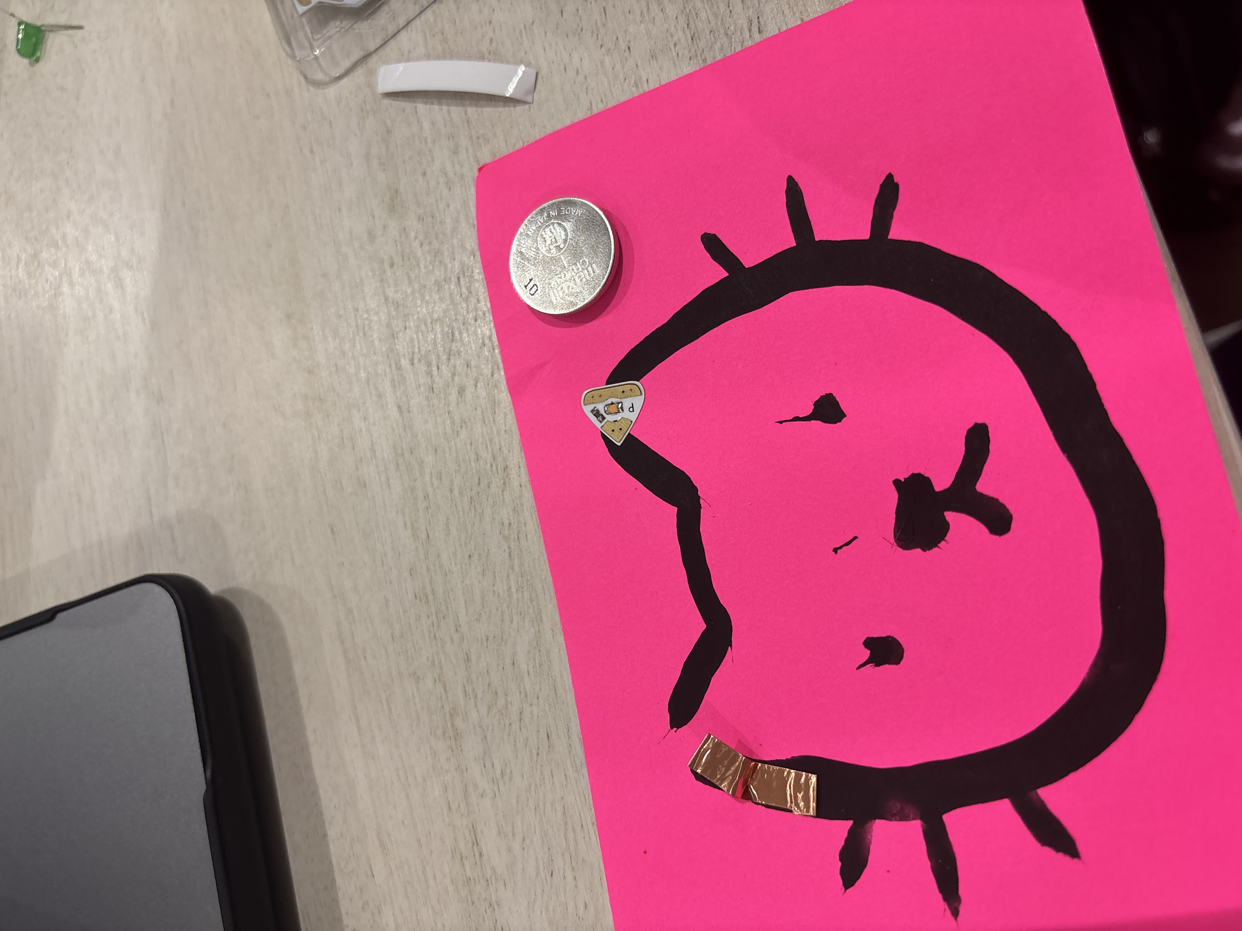 Paint circuit with conductive paint, a battery, and a light bulb.