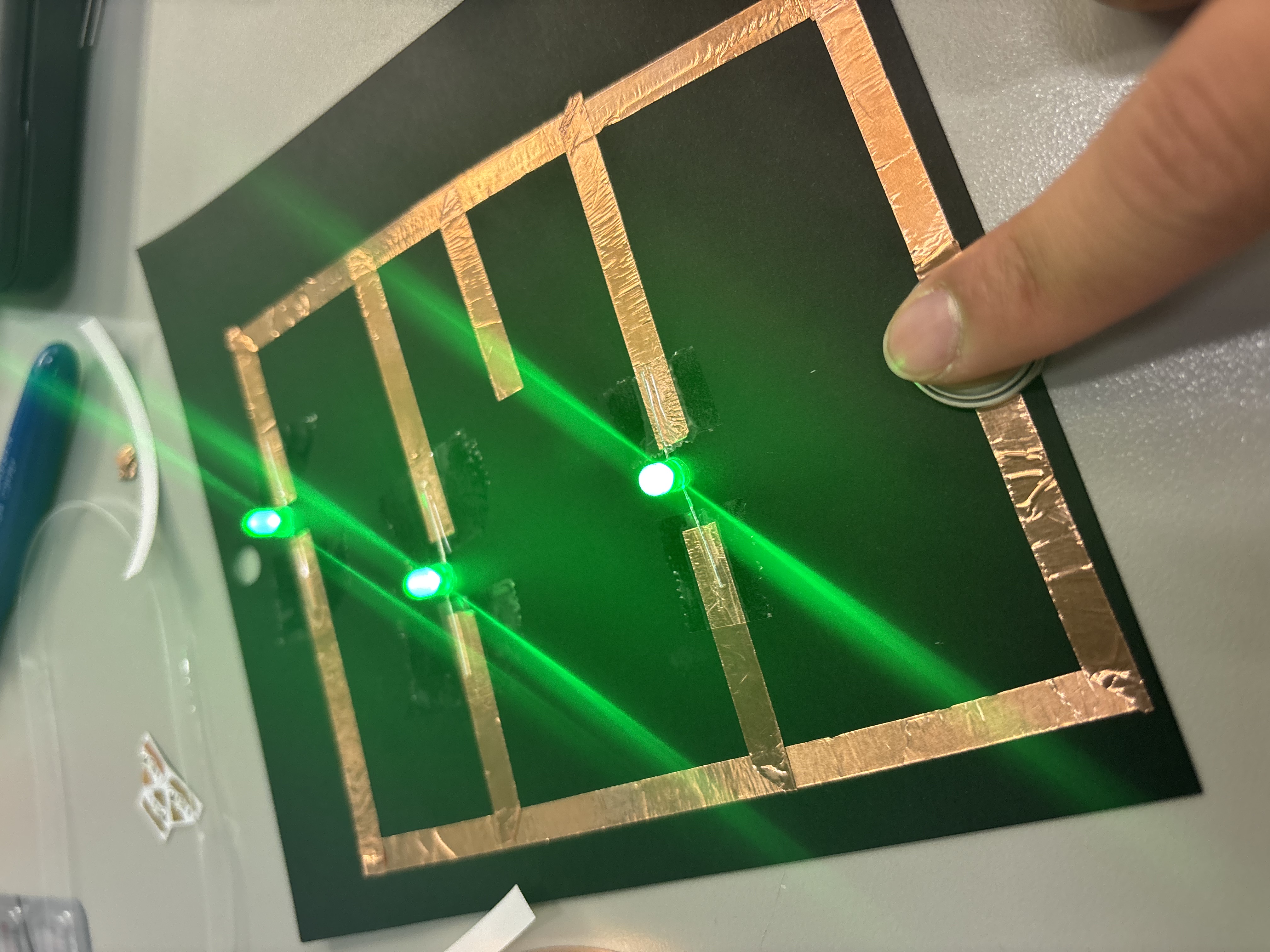 First paper circuit using copper tape, a battery, and three lights.